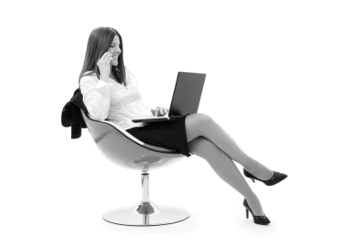 businesswoman in chair with laptop and phone